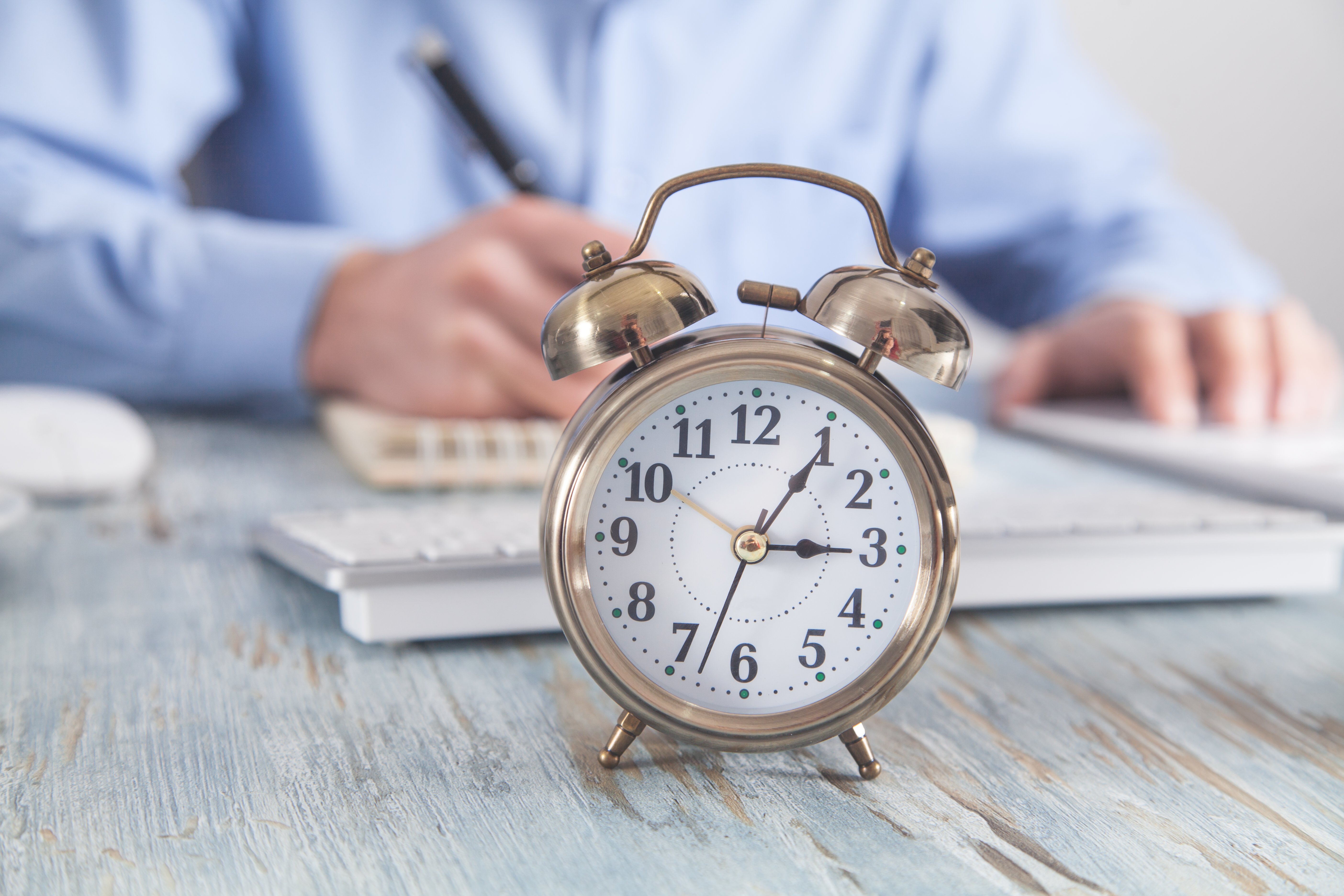 alarm-clock-desk-businessman-working-office