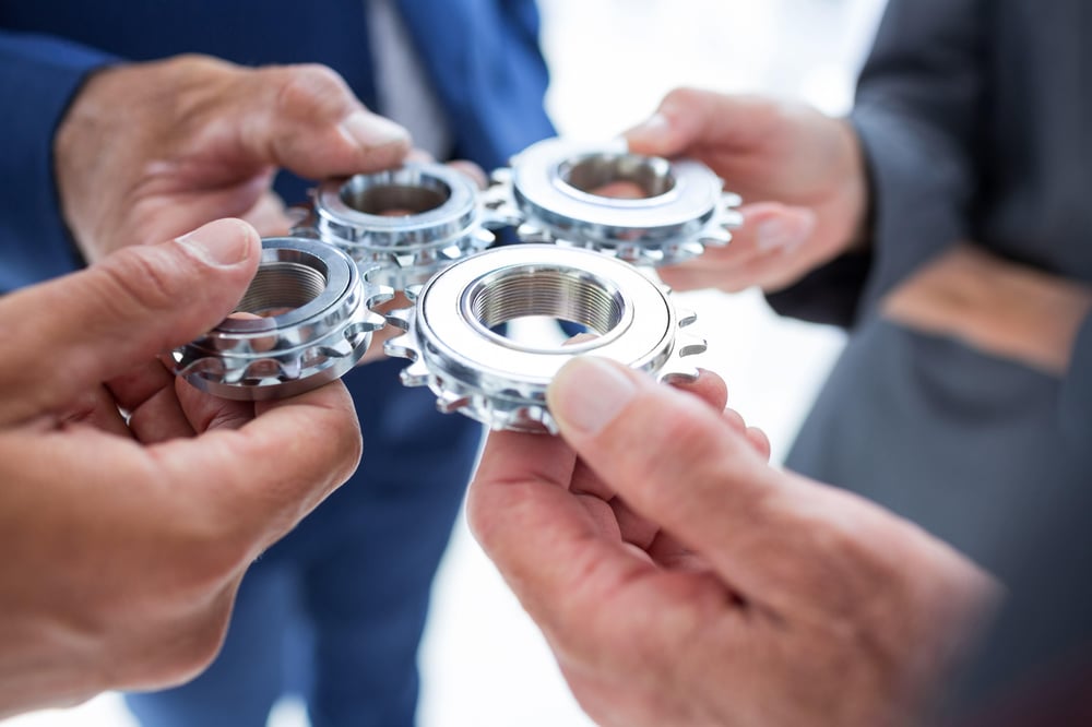 business-colleagues-holding-cog