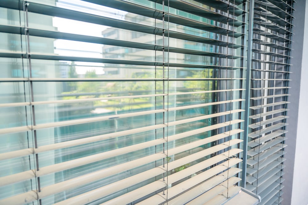 close-up-aluminum-window-blinds-with-tilt-mechanism-slats-sunlight-regulation