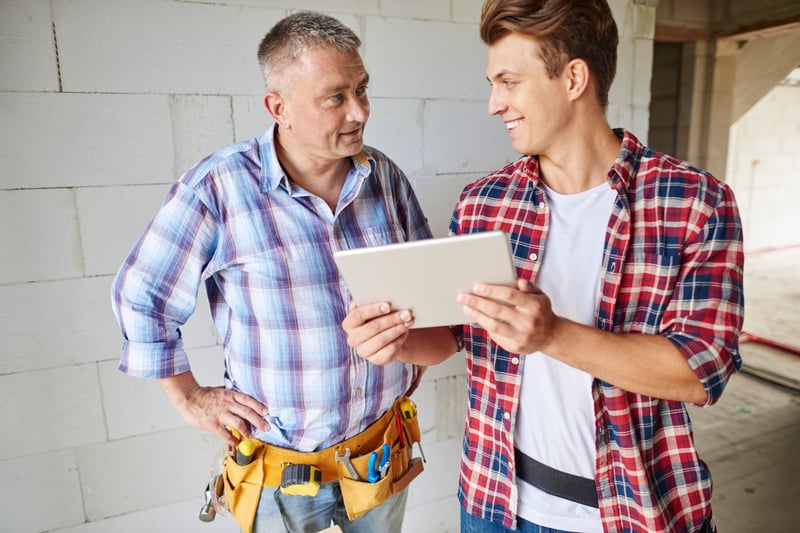 close-up-experienced-carpenter-his-younger-employee