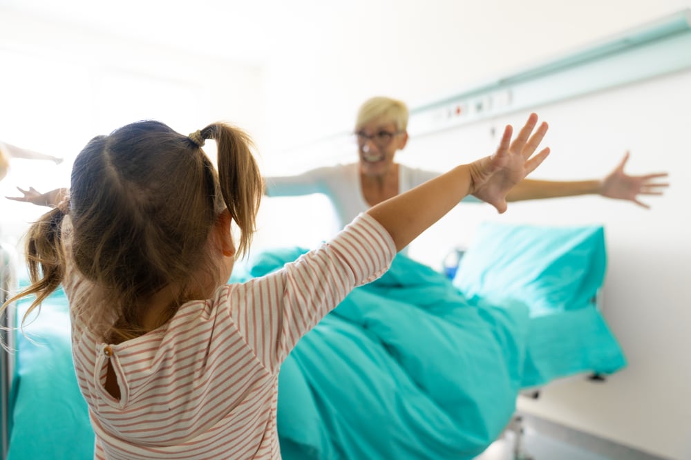 closeup-unrecognizable-female-child-raising-hands-embrace-her-grandmother-lying-hospital-bed