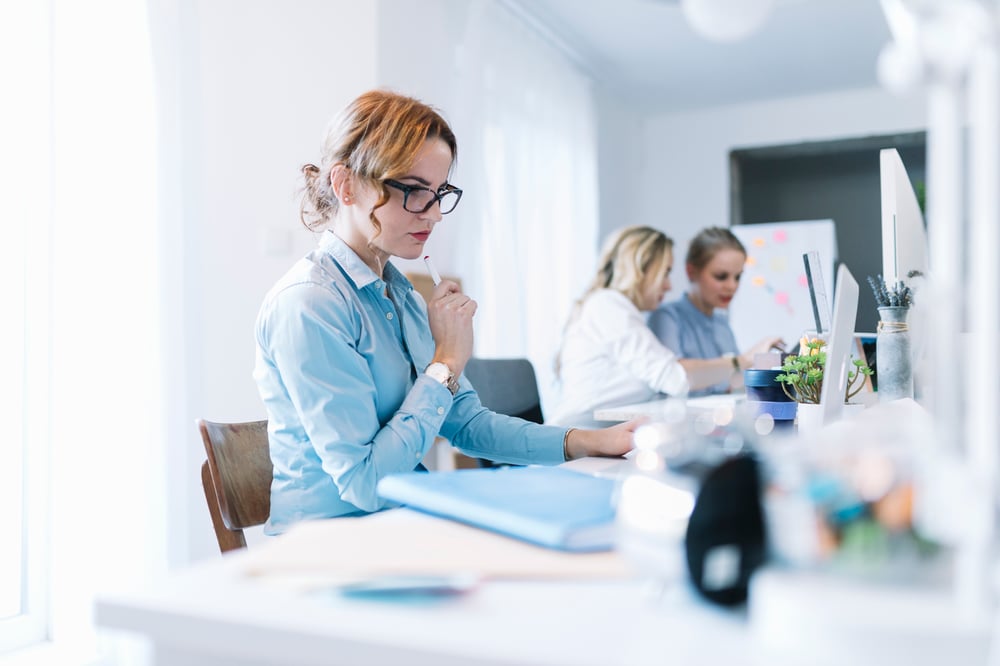 confident-young-businesswoman-working-laptop-office