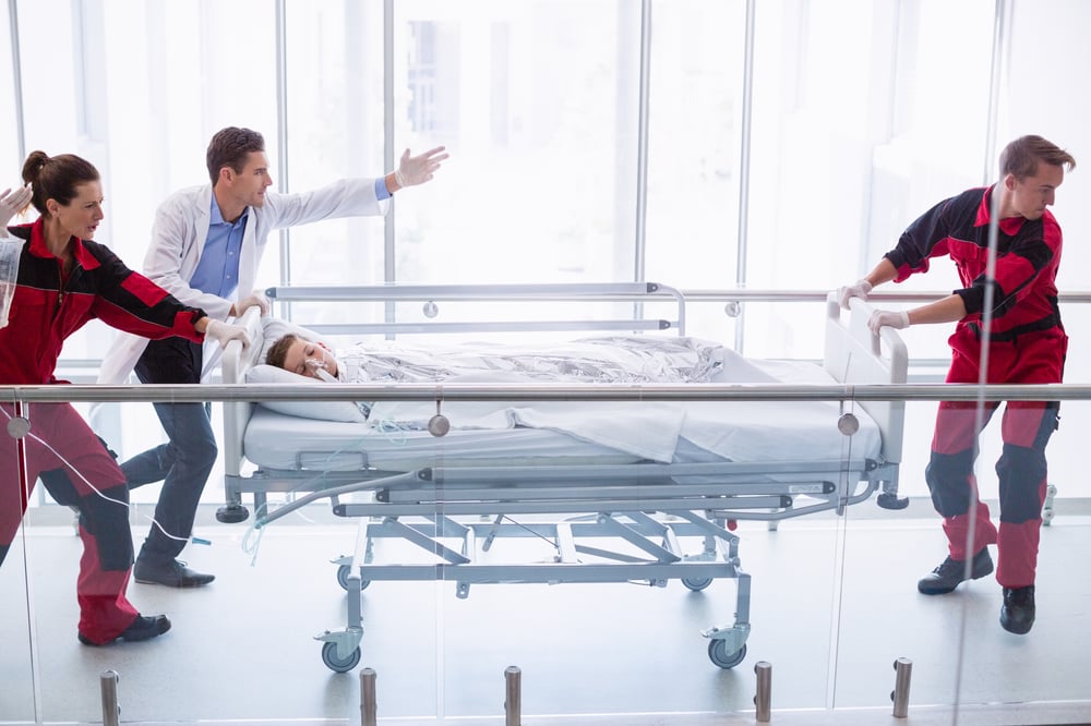 doctors-pushing-emergency-stretcher-bed-corridor