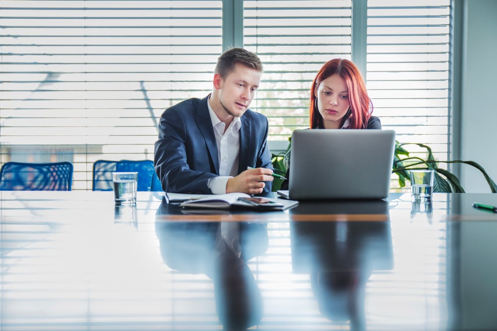 man-helping-coworker-with-job