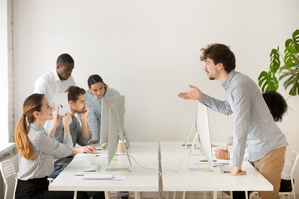 smiling-woman-explaining-corporate-paperwork-new-hire-office