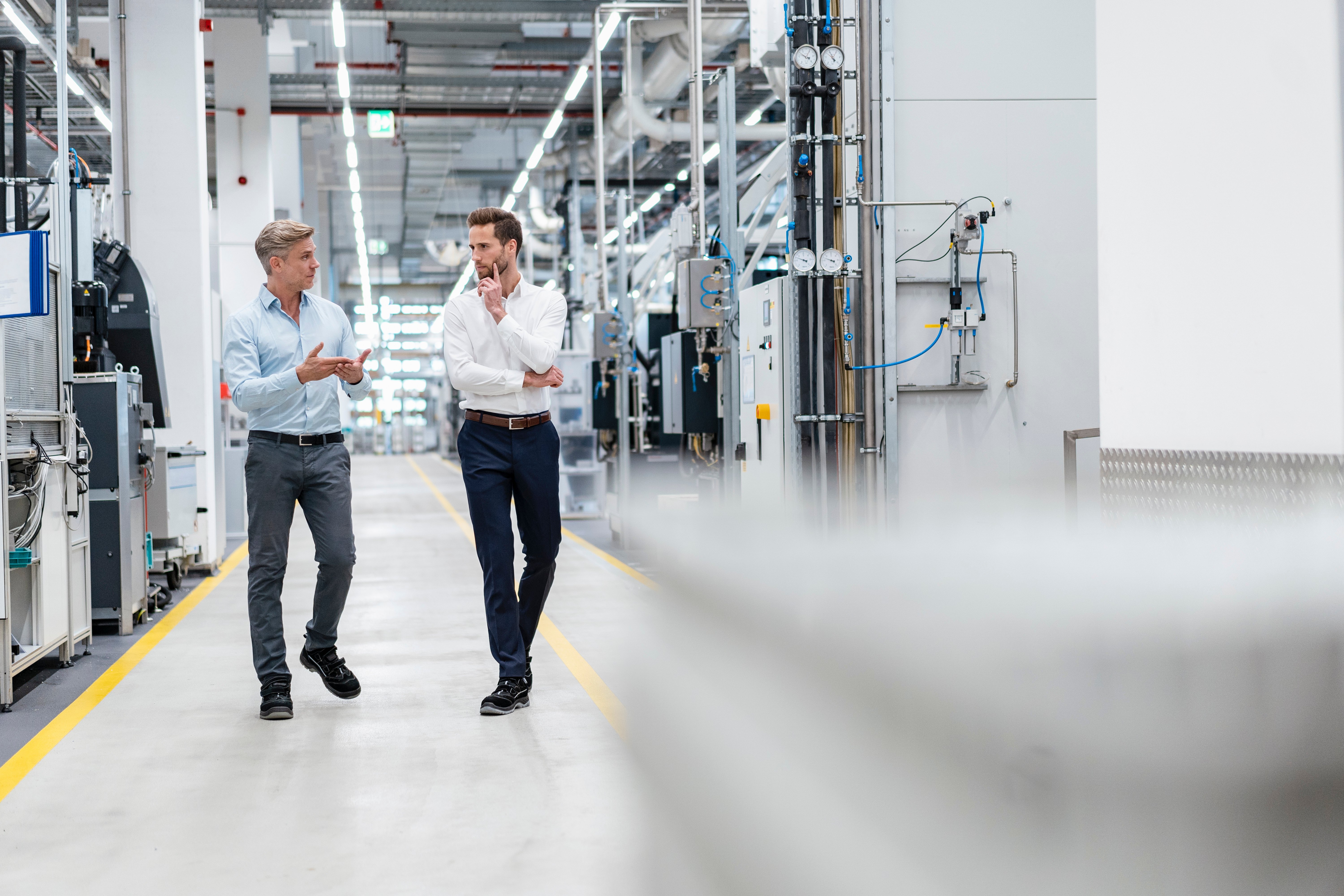 two-businessmen-talking-modern-factory